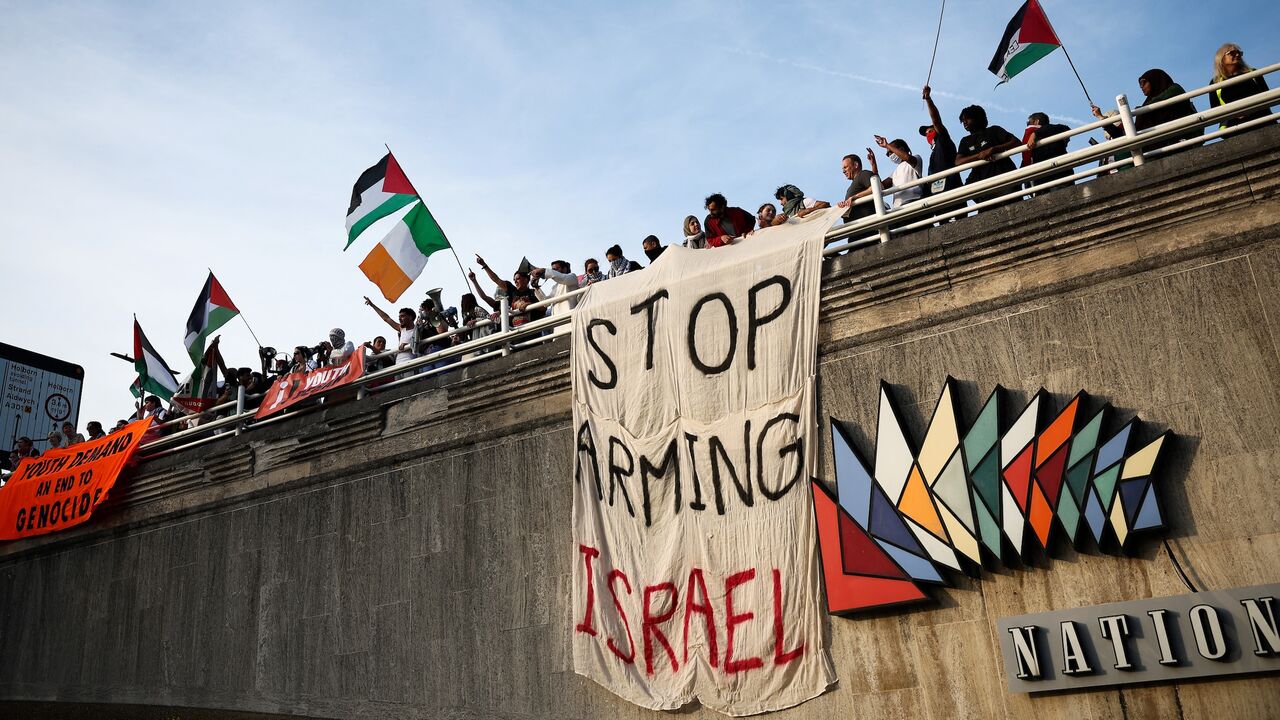 Protesters wave Palestinian flags.