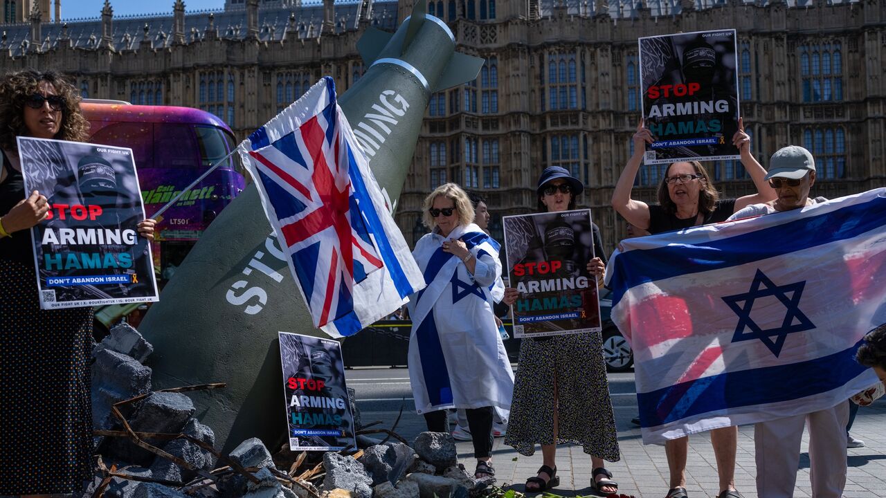 Pro-Israel demonstrators stage a counterprotest around an Oxfam installation.