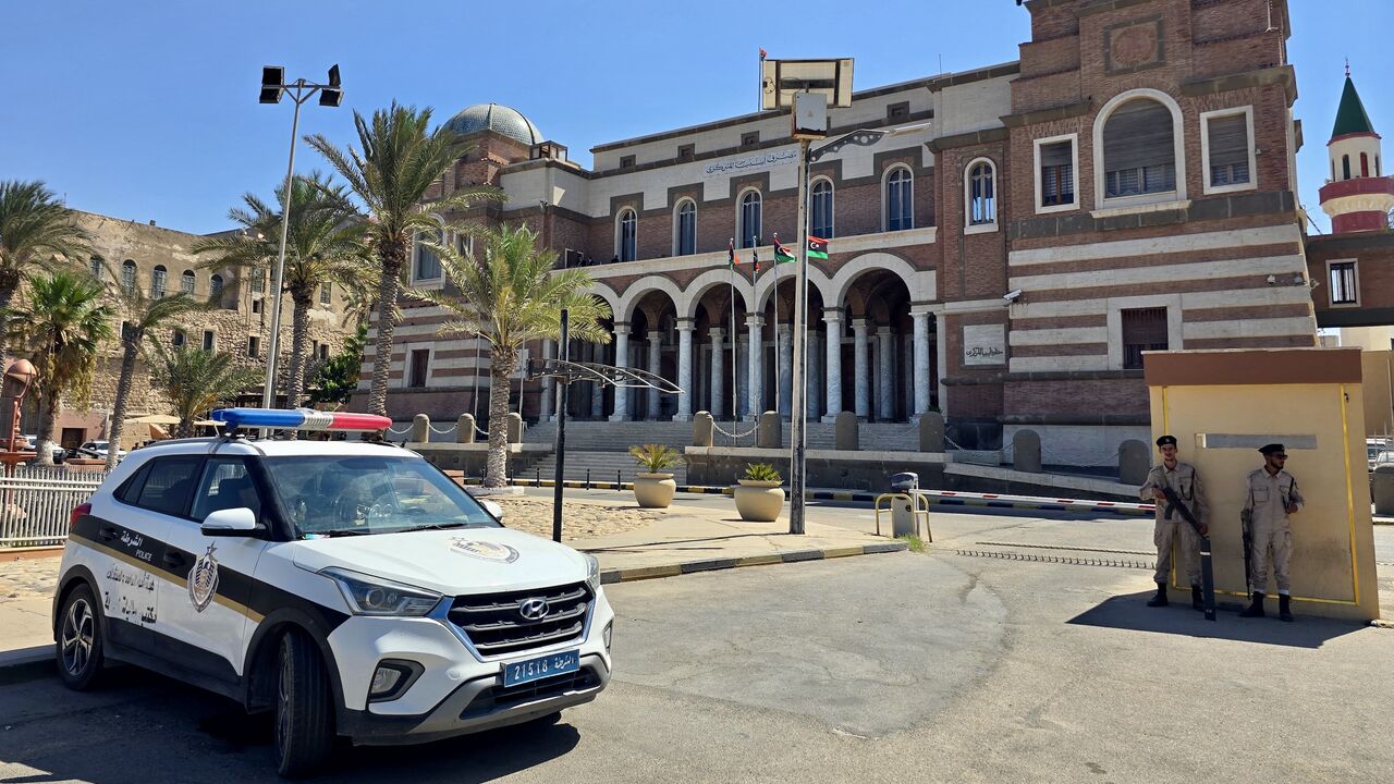 Police officers stand guard outside Libya's Central Bank headquarters in Tripoli on Aug. 27, 2024. 