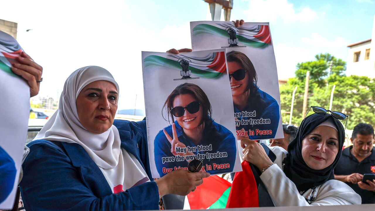 Palestinians and international activists lift portraits of slain Turkish American activist Aysenur Ezgi Eygi.