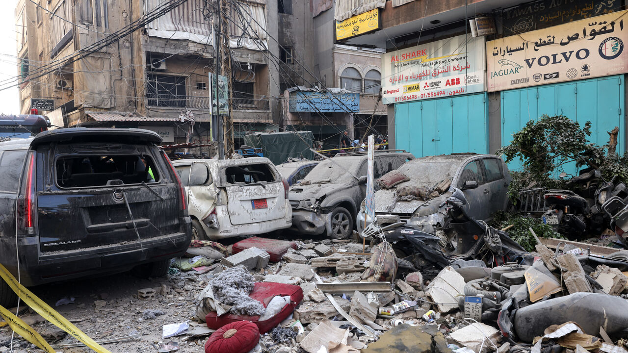 Debris lie around destroyed vehicles in a street under a residential building whose top two floors were hit by an Israeli strike in the Ghobeiri area of Beirut's southern suburbs on September 24, 2024. A Lebanese security source said on September 24 that an Israeli strike hit Hezbollah's south Beirut stronghold, as the Israel army confirmed it carried out the strike in the Lebanese capital without giving further details. (Photo by ANWAR AMRO / AFP) (Photo by ANWAR AMRO/AFP via Getty Images)