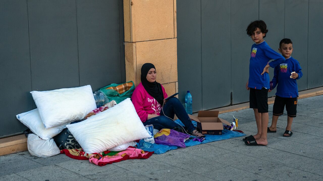 A woman sits with her belongings in Martyrs' Square as she seeks shelter after being displaced by Israeli airstrikes, on Sept. 29, 2024, in Beirut, Lebanon.