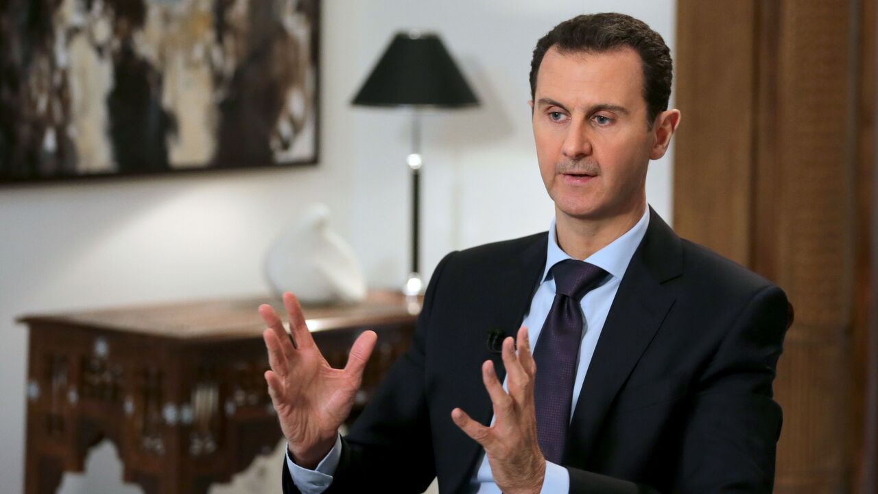 Syrian President Bashar al-Assad gestures during an exclusive interview with AFP in the capital, Damascus, on Feb. 11, 2016.