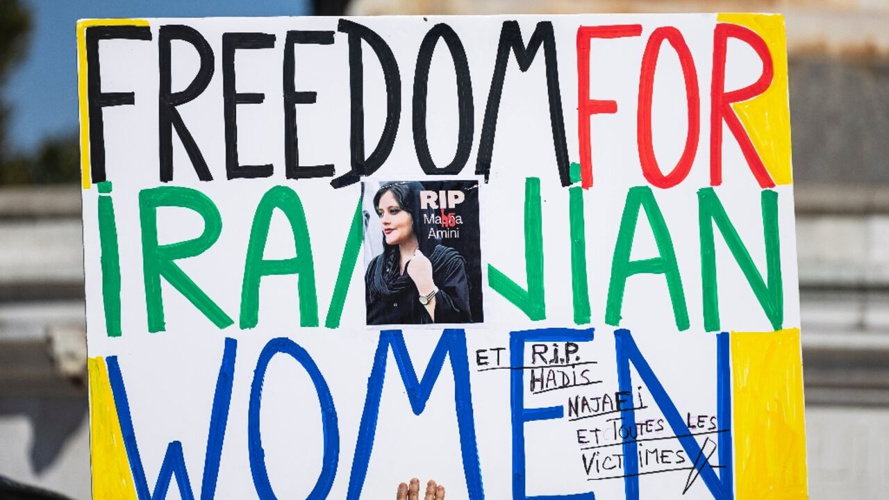 A placard carried during a march in Paris marking the second anniversary of the death in custody in Iran of Mahsa Amini