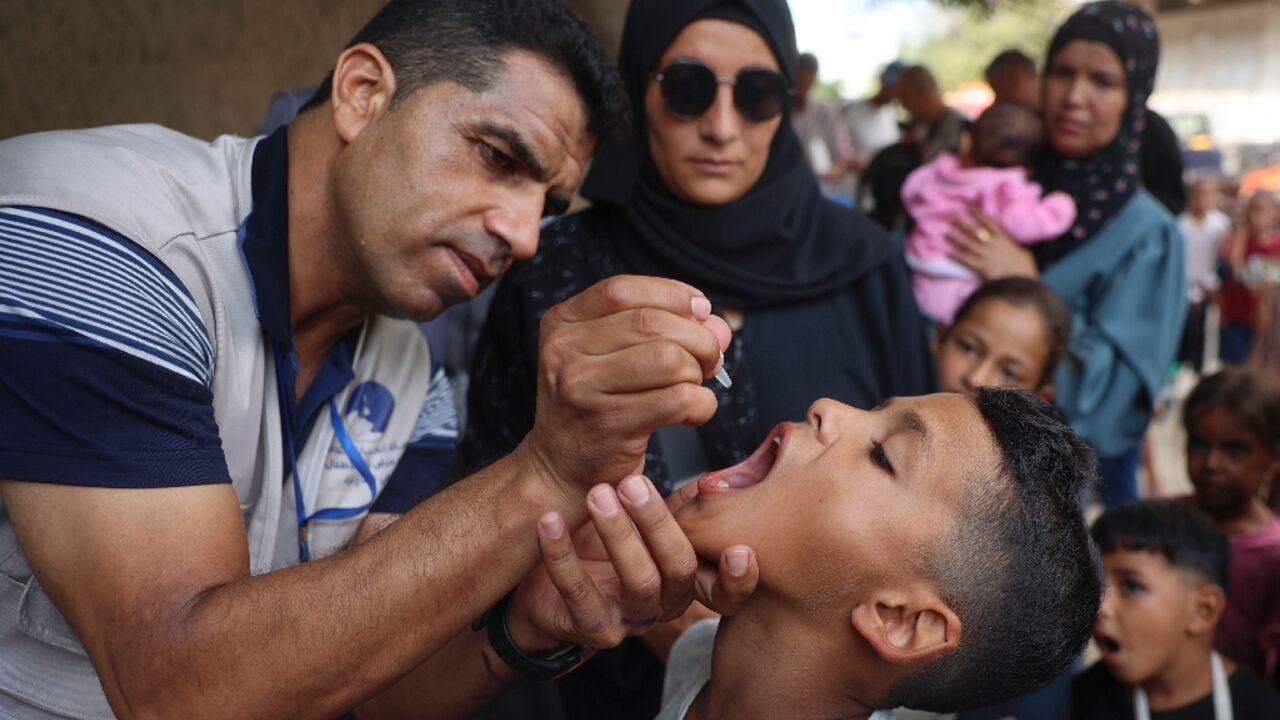 A health worker administers the polio vaccine to a Palestinian child in Zawayda in the central Gaza Strip