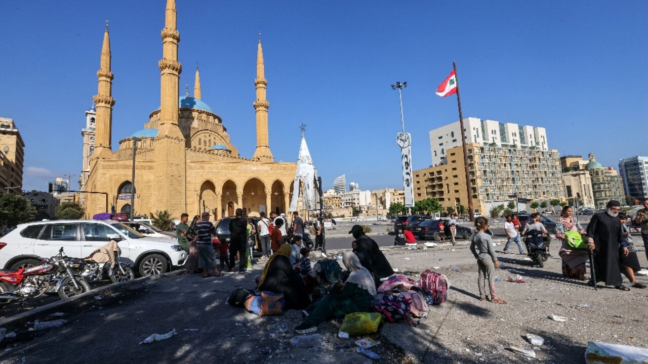 Many families who fled the southern suburbs spent the night in Beirut's Martyrs' Square Many families who fled the southern suburbs spent the night in Beirut's Martyrs' Square