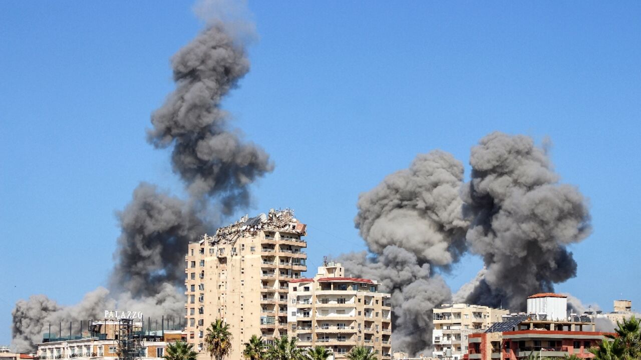 Plumes of back smoke rise over the Lebanese coastal city of Tyre after Israeli air strikes