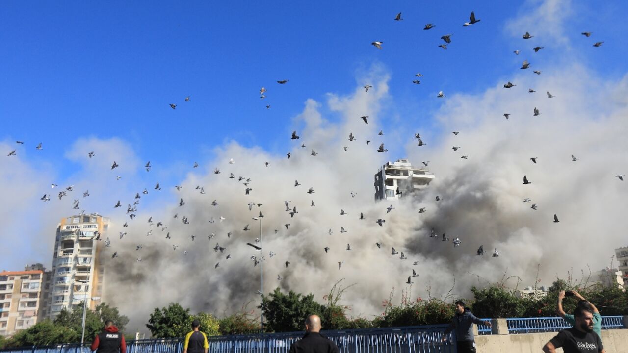 Smoke and pigeons rise after an Israeli strike on Beirut's southern suburbs