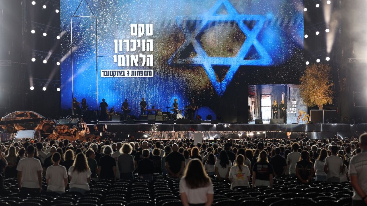 Participants at the memorial observe a moment's silence during the ceremony