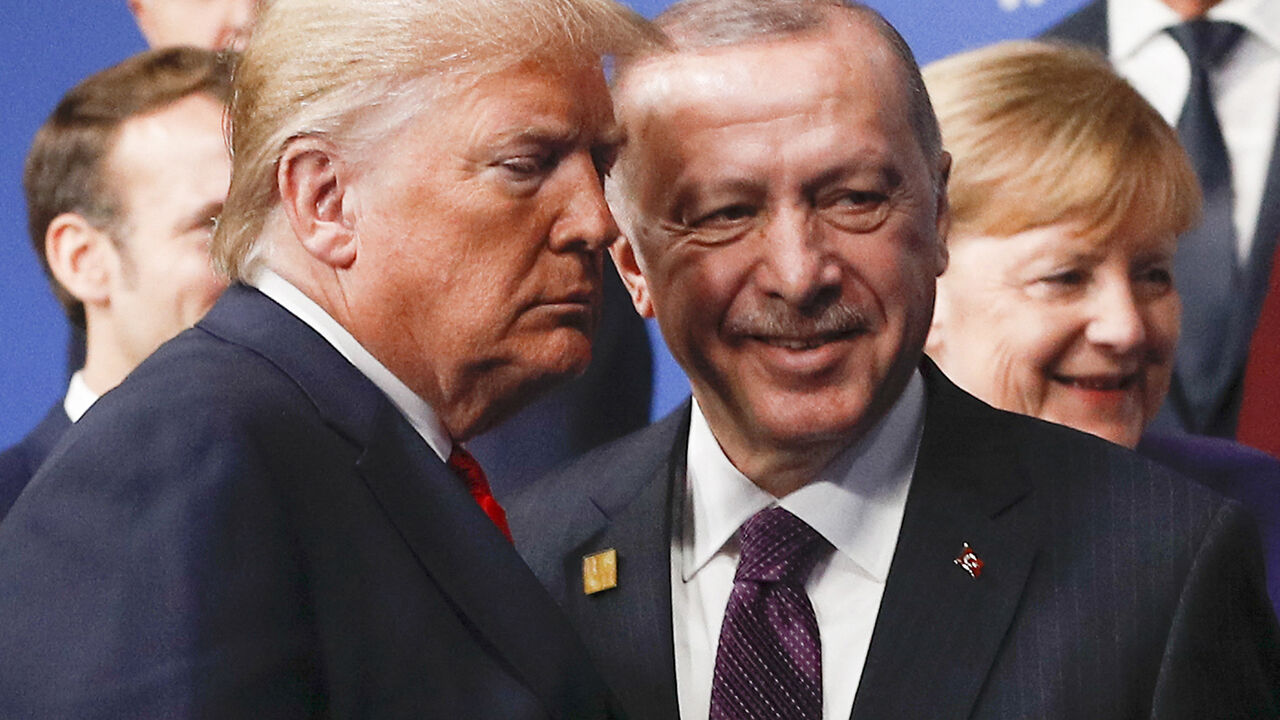 TOPSHOT - US President Donald Trump (L) and Turkey's President Recep Tayyip Erdogan (R) leave the stage after the family photo to head to the plenary session at the NATO summit at the Grove hotel in Watford, northeast of London on December 4, 2019. (Photo by PETER NICHOLLS / POOL / AFP) (Photo by PETER NICHOLLS/POOL/AFP via Getty Images)