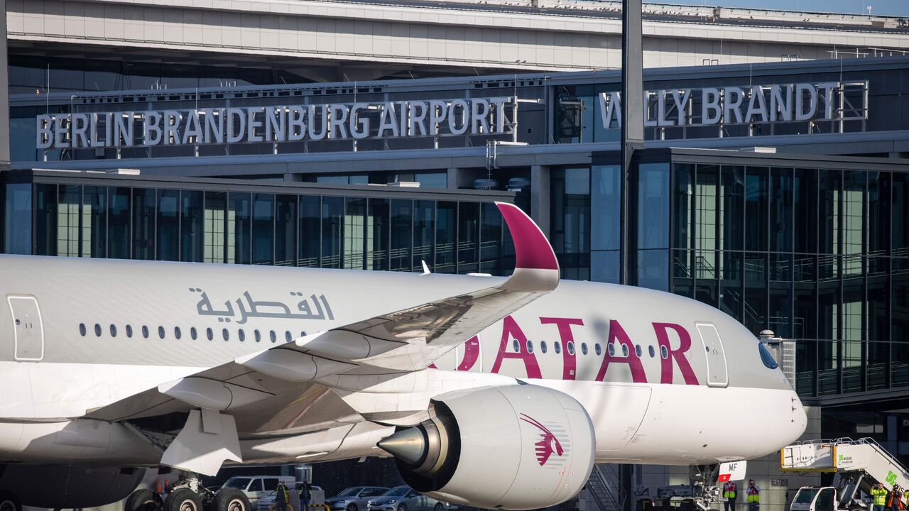 An Airbus A350 plane of Qatar Airways from Doha parks after it landed at Berlin's airport "Berlin Brandenburg Airport Willy Brandt", during the opening of the southern runway of the airport, in Schoenefeld, southeast of Berlin, on November 4, 2020. - Passenger flights are to began landing on October 31, 2020 at Berlin's new international airport, a moment many Germans thought they might never see after years of embarrassing delays and spiralling costs. (Photo by Odd ANDERSEN / AFP) (Photo by ODD ANDERSEN/AF