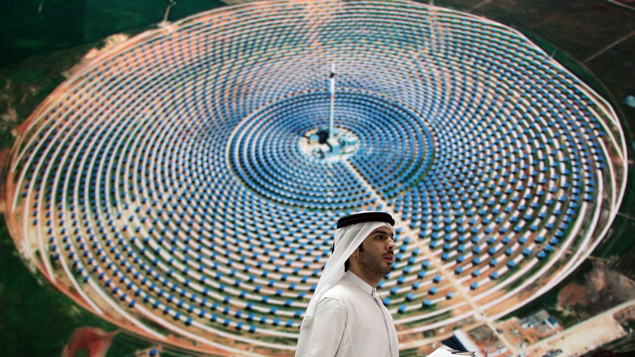 An Emirati man walks in front of the stand of Masdar City at the World Future Energy Summit exhibition in Abu Dhabi on Jan. 18, 2012.