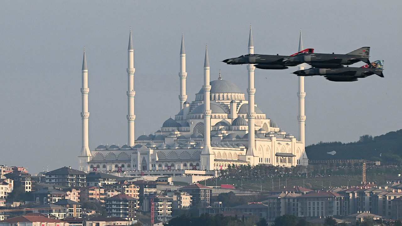 Turkish air force fighter jets perform a military parade over the Bosphorus as Camlica mosque is seen in the background to mark the 100th anniversary of Turkish Republic in Istanbul on Oct. 29,2023.  