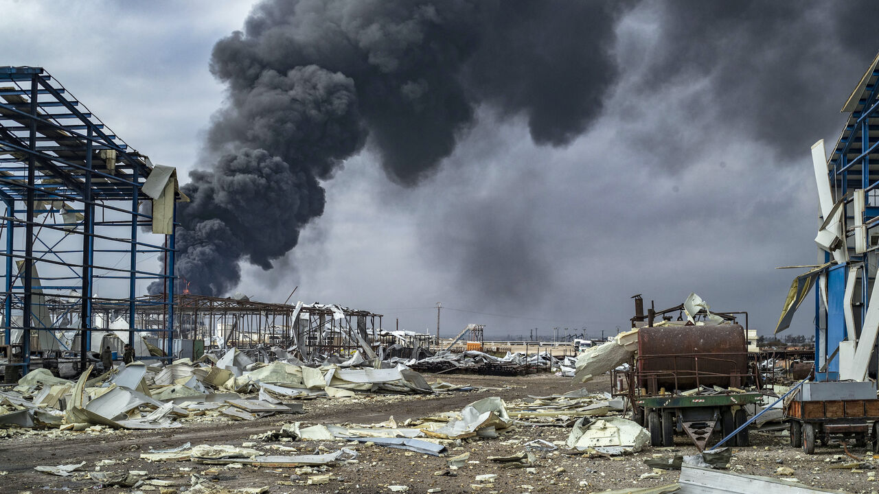 Thick smoke billows from a raging fire at a storage tank of the al-Awda oil field facility near al-Qahtaniyah in northeastern Syria close to the Turkish border on Dec. 24, 2023, a day after a reported Turkish strike. 