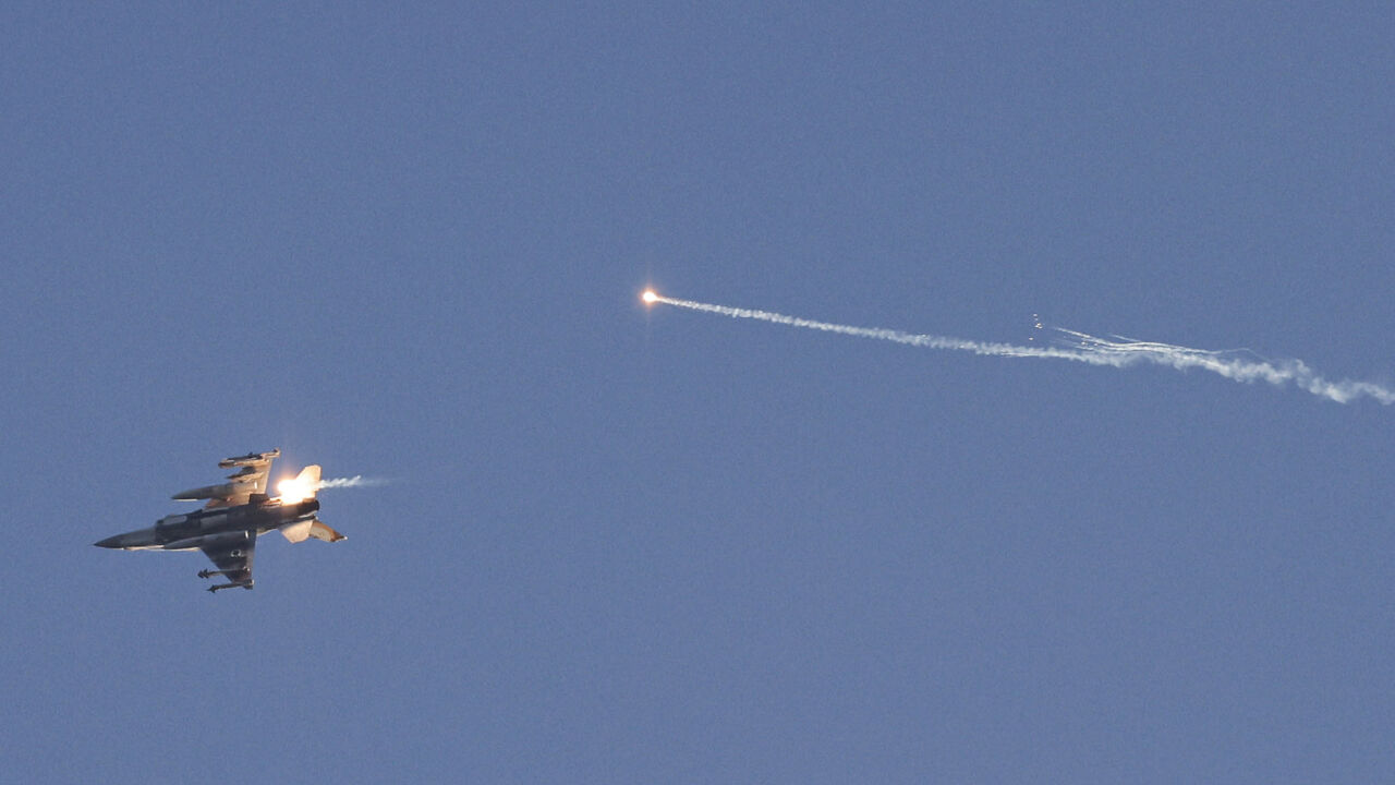 This picture taken from a position in northern Israel shows an Israeli Air Force fighter jet firing flares as it flies to intercept a hostile craft that launched from Lebanon over the border area with south Lebanon on July 7, 2024, amid ongoing cross-border clashes between Israeli troops and Hezbollah fighters. (Photo by Jalaa MAREY / AFP) (Photo by JALAA MAREY/AFP via Getty Images)