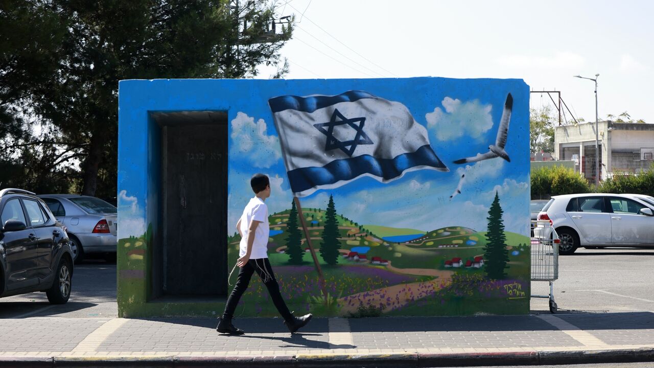 A man walks in front of the entrance of a bomb shelter in the northern Israeli town of Safed on September 29, 2024. (Photo by Menahem Kahana / AFP) (Photo by MENAHEM KAHANA/AFP via Getty Images)