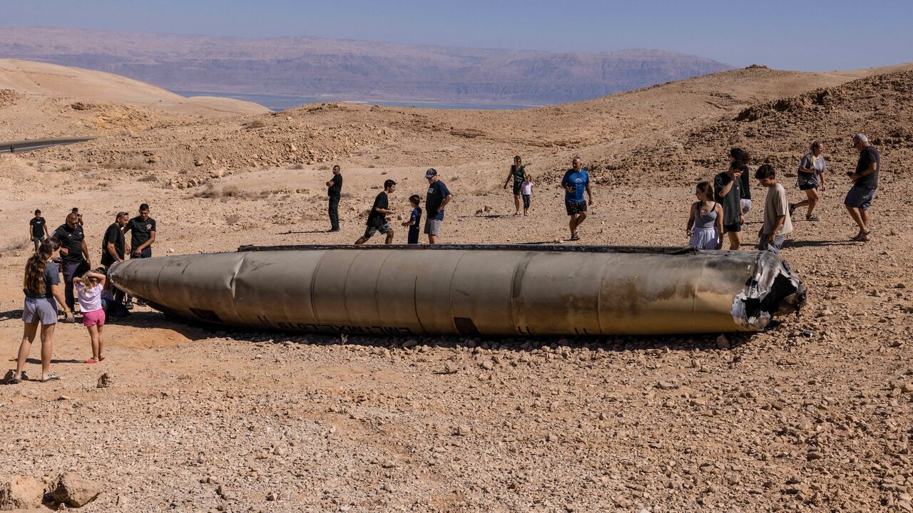 People visit the site of the remains of an Iranian missile in the Negev desert near Arad, Oct. 3, 2024.