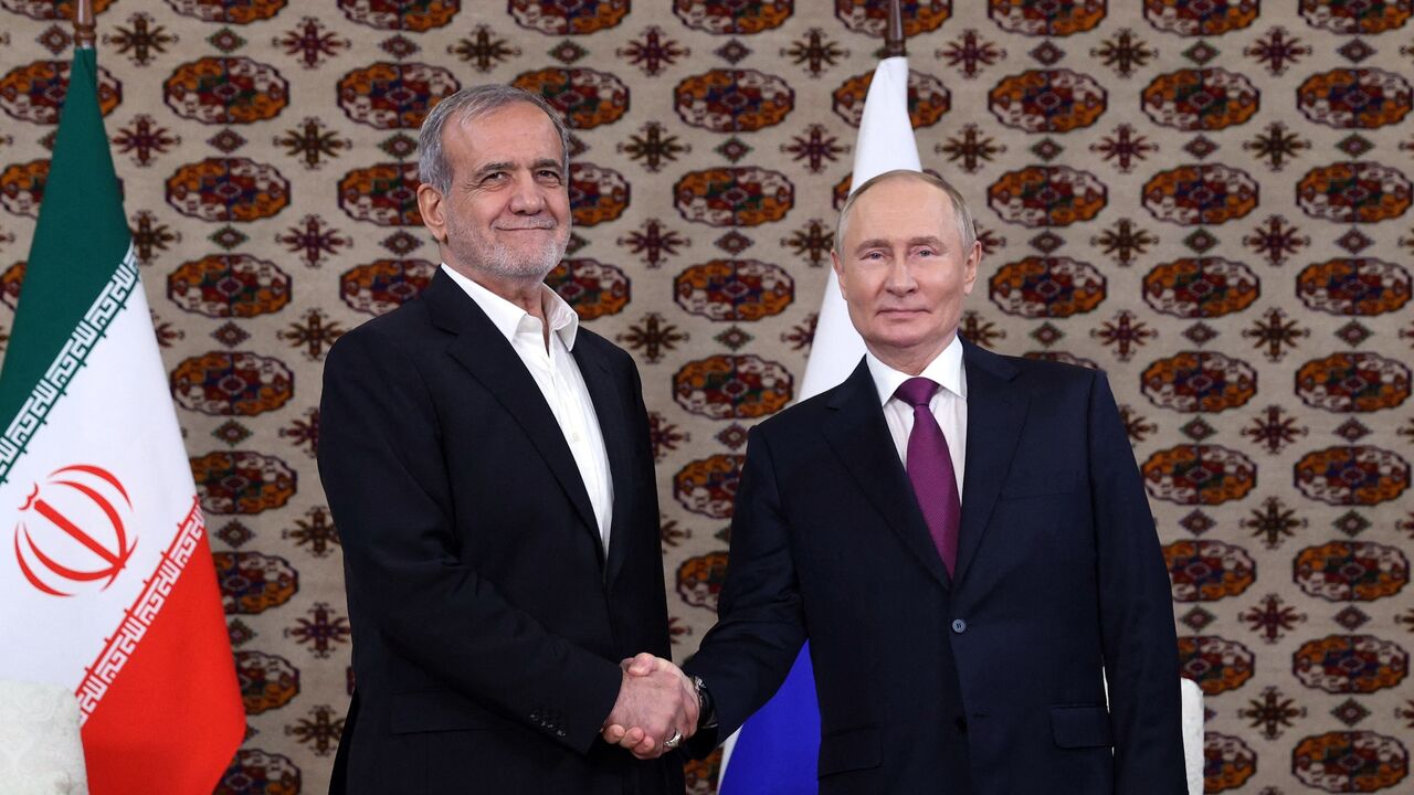 Pool photograph distributed by the Russian state agency Sputnik of Russian President Vladimir Putin meeting with Iranian President Masoud Pezeshkian in Ashgabat, Turkmenistan, Oct. 11, 2024.