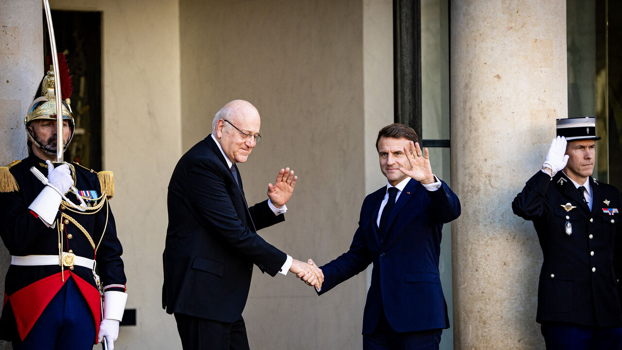 France s President Emmanuel Macron receives Lebanon s Prime Minister Najib MIKATI before their bilateral meeting at the Elysee Palace in Paris, France on October 23, 2024. Context of war between Lebanon and Israel, extension of the Israeli-Palestinian conflict, solidarity with lebanese people, the two men shake hands on the stoop at the top of the steps and look towards the photographers. (Photo by Amaury Cornu / Hans Lucas / Hans Lucas via AFP) (Photo by AMAURY CORNU/Hans Lucas/AFP via Getty Images)