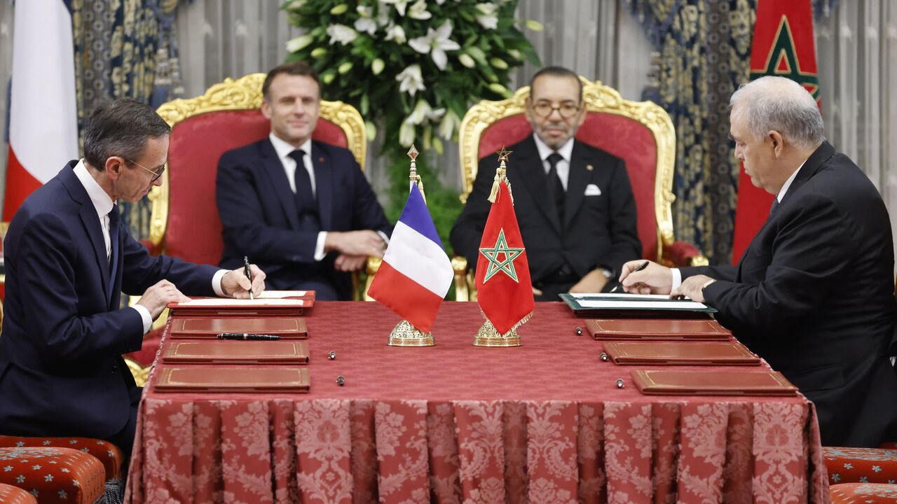 Morocco's King Mohammed VI (C-R) and France's President Emmanuel Macron (C-L).