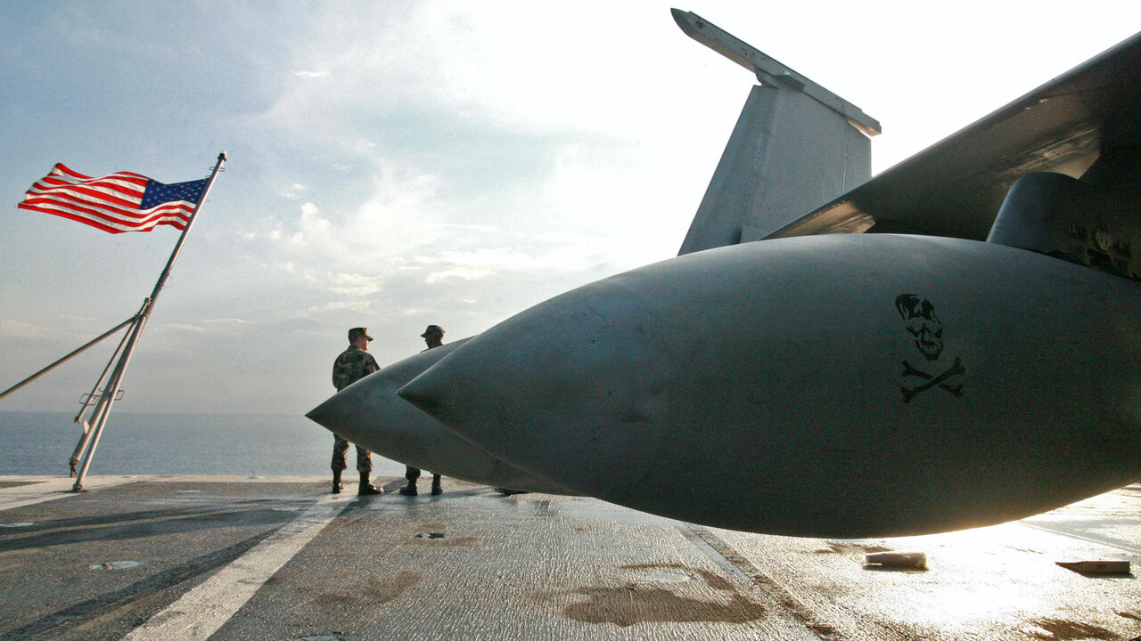 US navy men stand aboard the USS Eisenhower, one of the world's largest warships, off the Cypriot coast, Oct. 25, 2006.