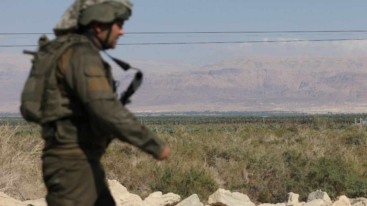 An Israeli soldier patrols the area south of the Dead Sea where the army said two attackers entered from Jordan