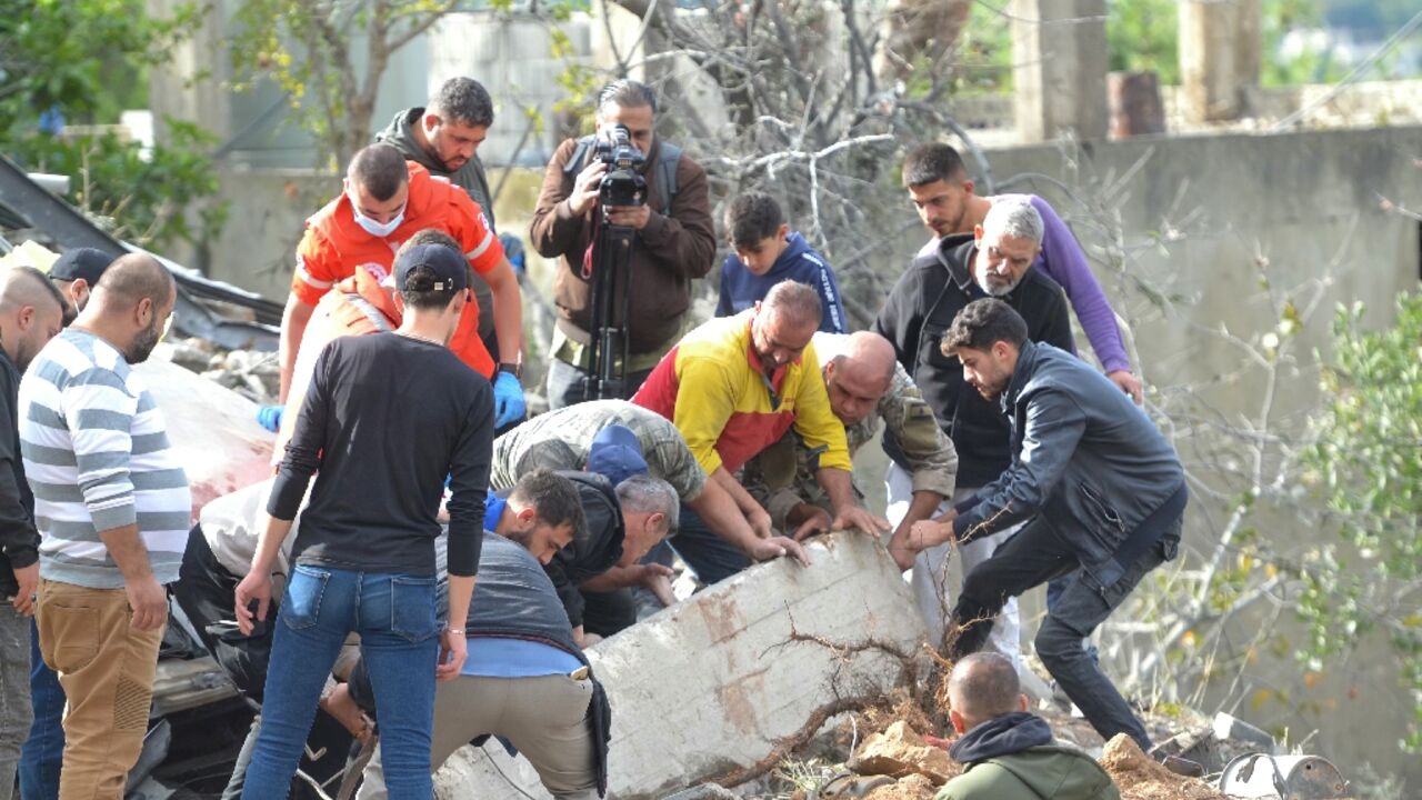 First responders and locals search at the site of an Israeli strike in Ain Yaacoub, Akkar region, on November 12, 2024, amid the ongoing war between Israel and Hezbollah.