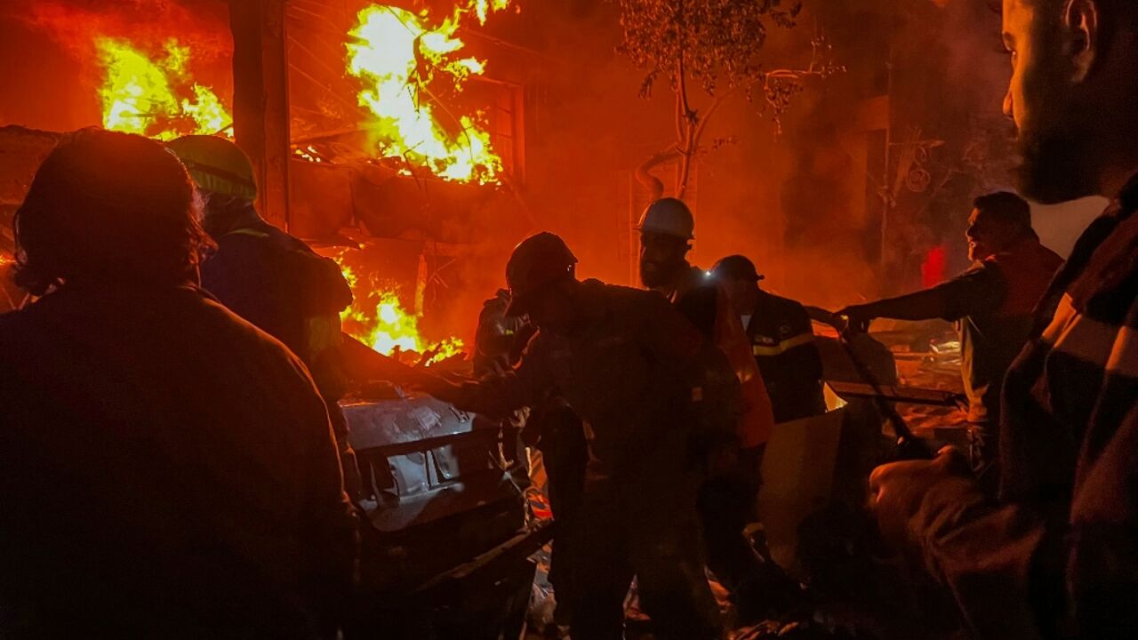 Emergency services fight flames at the site of the Israeli strike on central Beirut Emergency services fight flames at the site of the Israeli strike on central Beirut