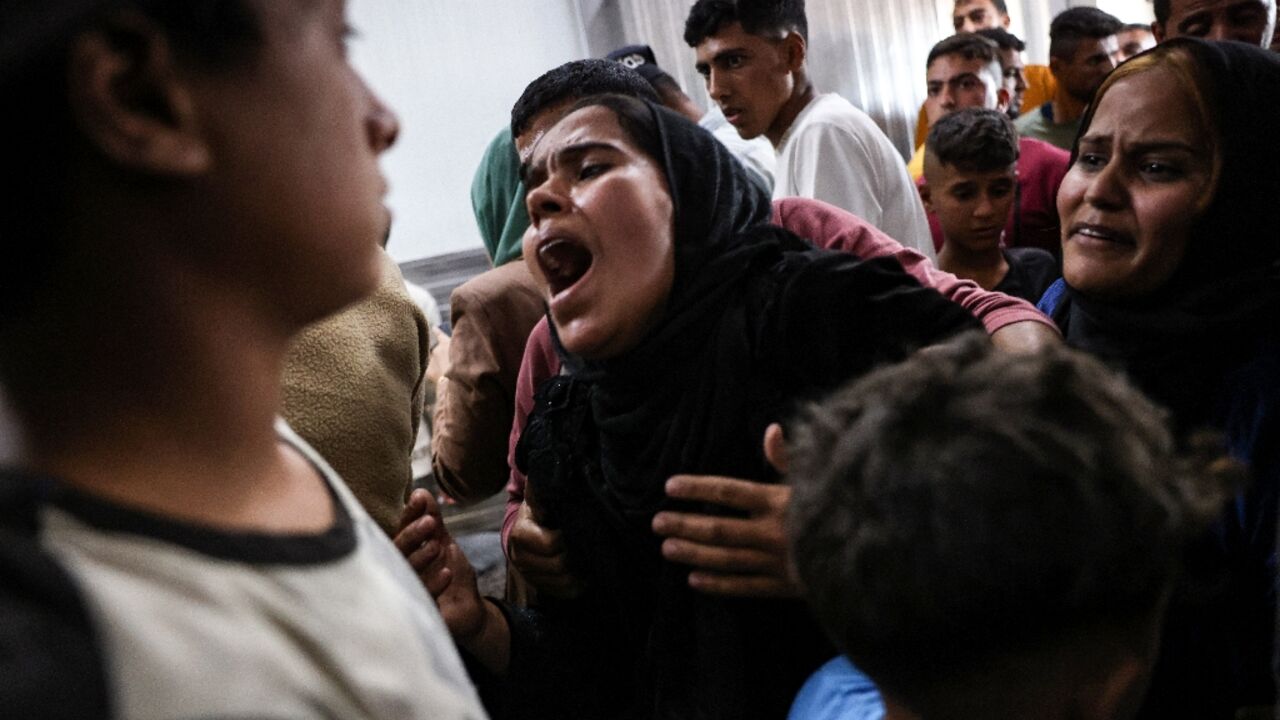 A Palestinian woman who lost relatives in an Israeli strike reacts after seeing their bodies at the Nasser hospital in Khan Yunis