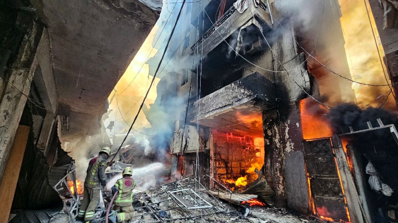 Firefighters battle the flames after an Israeli air strike in the Hadath neighbourhood of Beirut's southern suburbs 