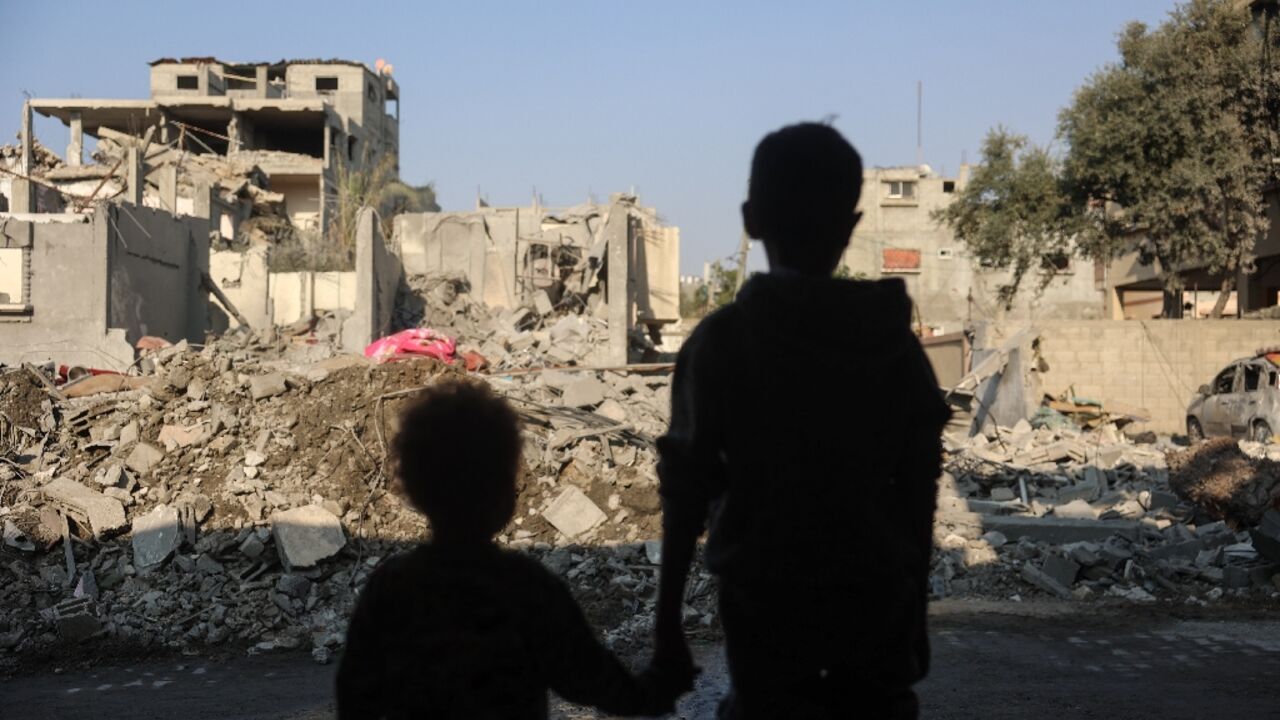 Gazan children stare at destruction from an Israeli strike on Nuseirat refugee camp Gazan children stare at destruction from an Israeli strike on Nuseirat refugee camp