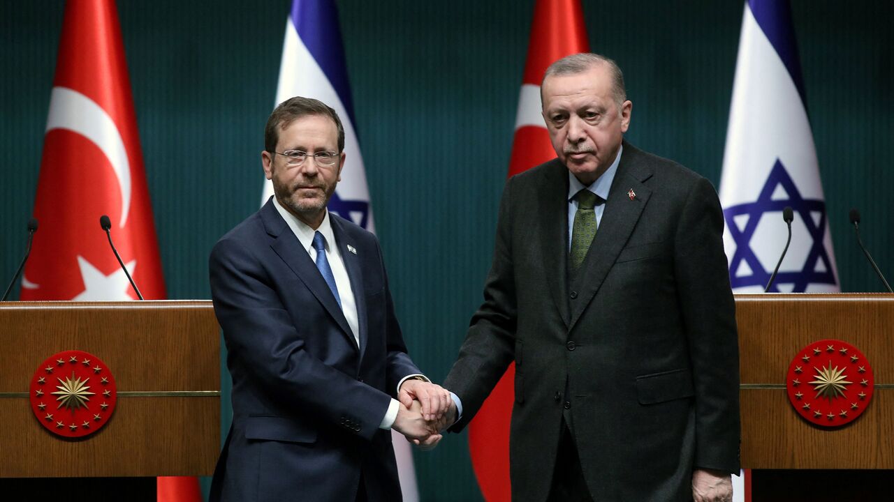 Israeli President Isaac Herzog (L) and his Turkish counterpart Tayyip Erdogan shake hands during a press conference in Ankara, on March 9, 2022. (Photo by AFP) (Photo by STR/AFP via Getty Images)