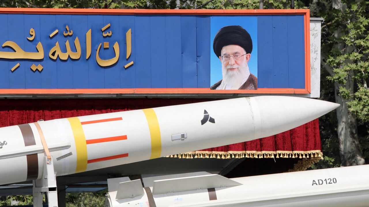 An Iranian military truck carries parts of a Sayad 4-B missile past a portrait of Iran's supreme leader, Ayatollah Ali Khamenei, during a military parade as part of a ceremony marking the country's annual army day, Tehran, April 17, 2024.