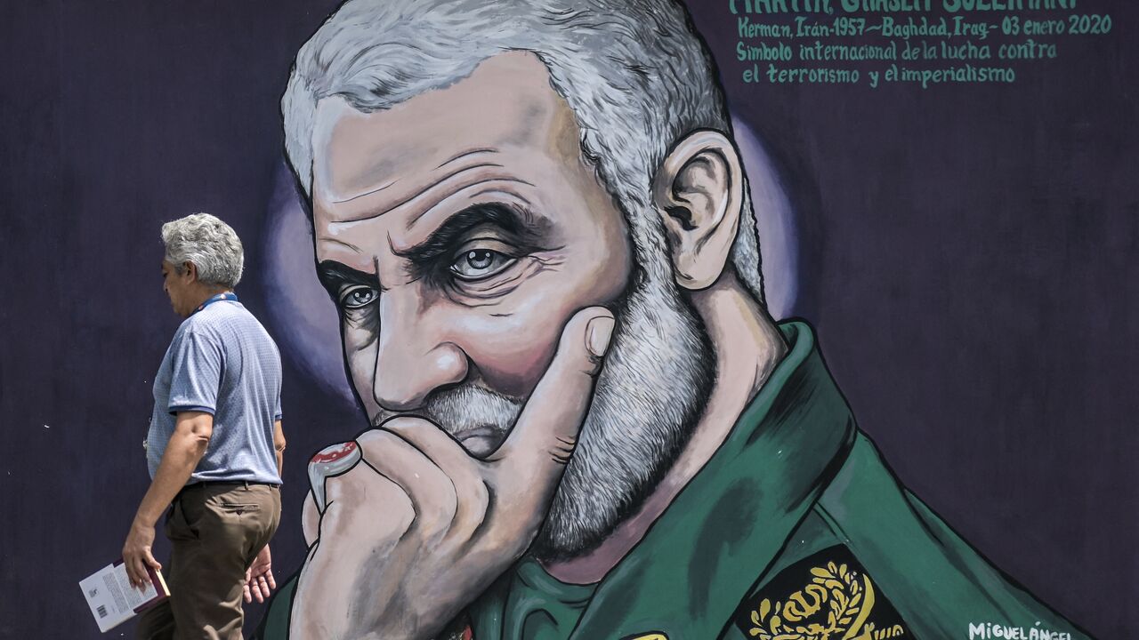 A man walks past a mural depicting slain commander of the IRGC's Quds Force Qasem Soleimani in Caracas, Venezuela, on April 26, 2024.