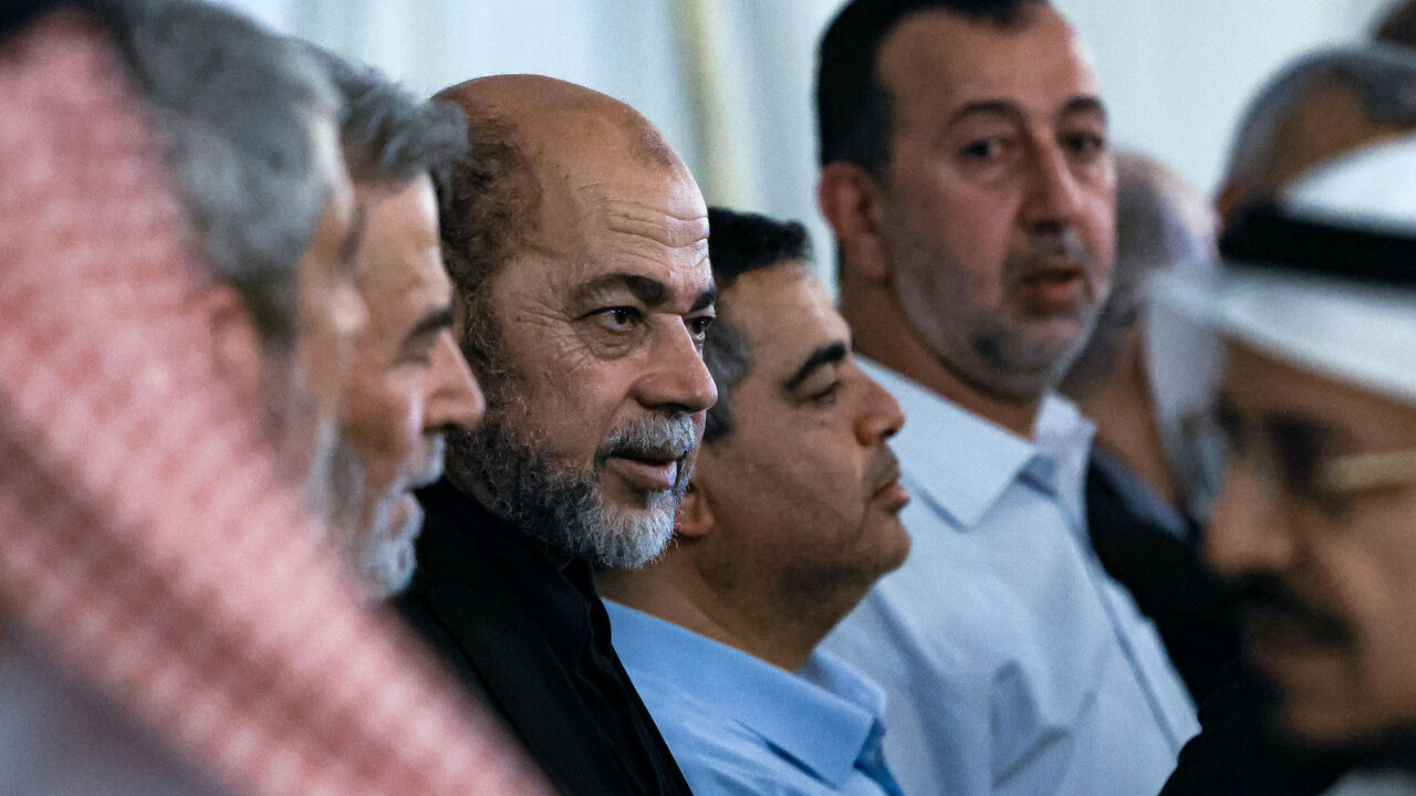 Mourners offer their condolences to senior member of Hamas' political bureau Musa Abu Marzuk (C) during the funeral of the slain Hamas political leader Ismail Haniyeh, in Doha on August 2, 2024. 