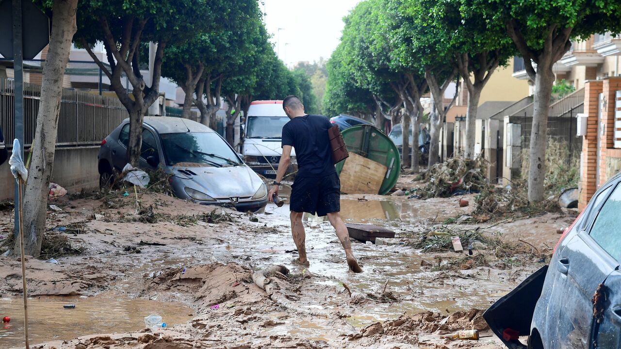 A man walks in a street covered in mud in a flooded area in Picanya, near Valencia, eastern Spain, on Oct. 30, 2024.