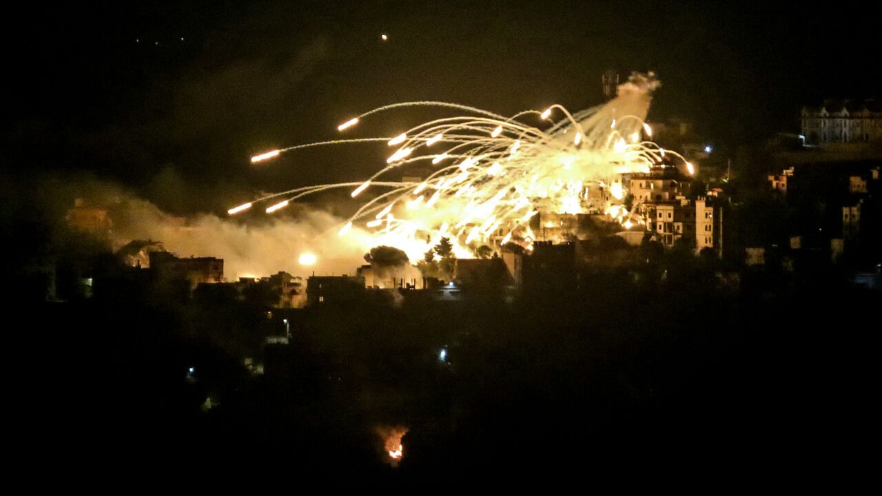 A picture taken from the area of Marjeyoun in southern Lebanon shows explosions over buildings in the town of Khiam during Israeli bombardment on Oct. 31, 2024.