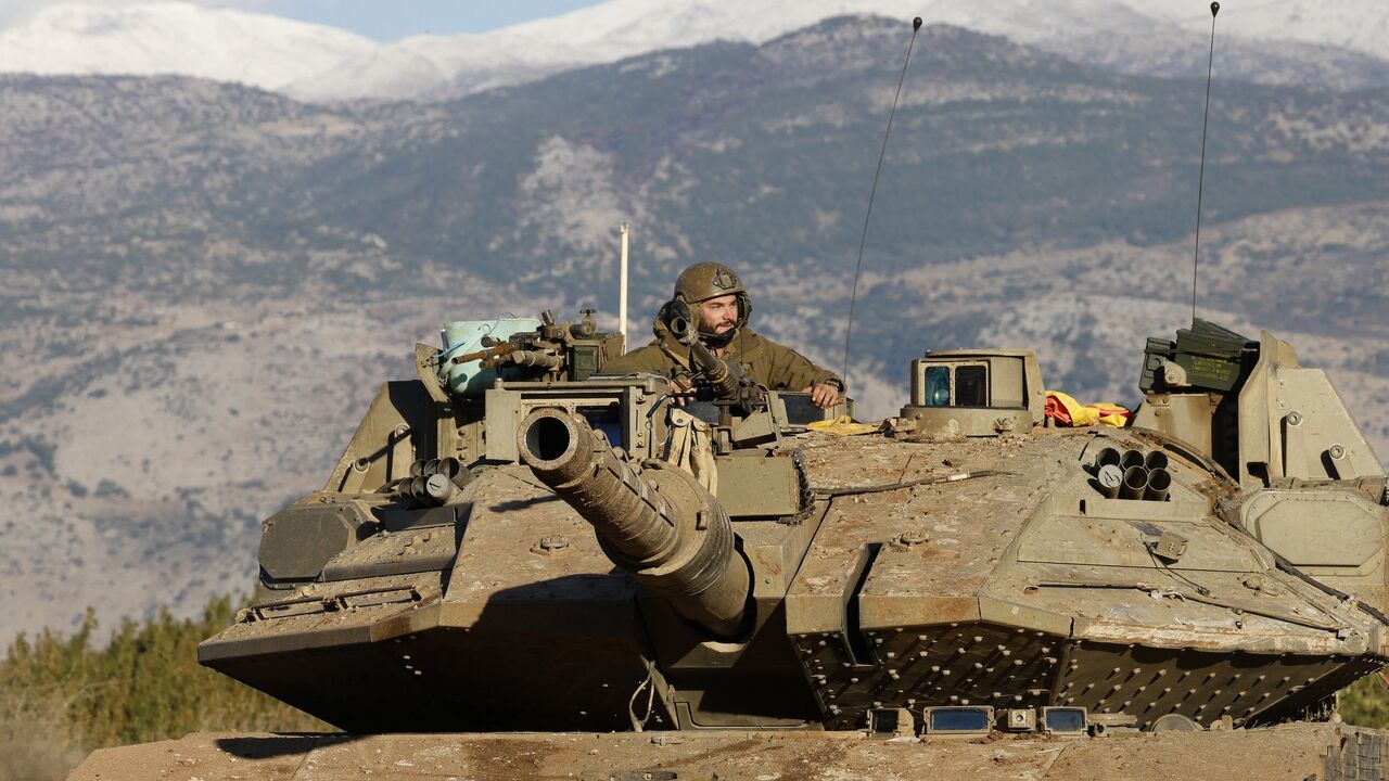 An Israeli soldier sits in a tank stationed near the border with Lebanon in the Upper Galilee area in northern Israel, on Nov. 26, 2024.