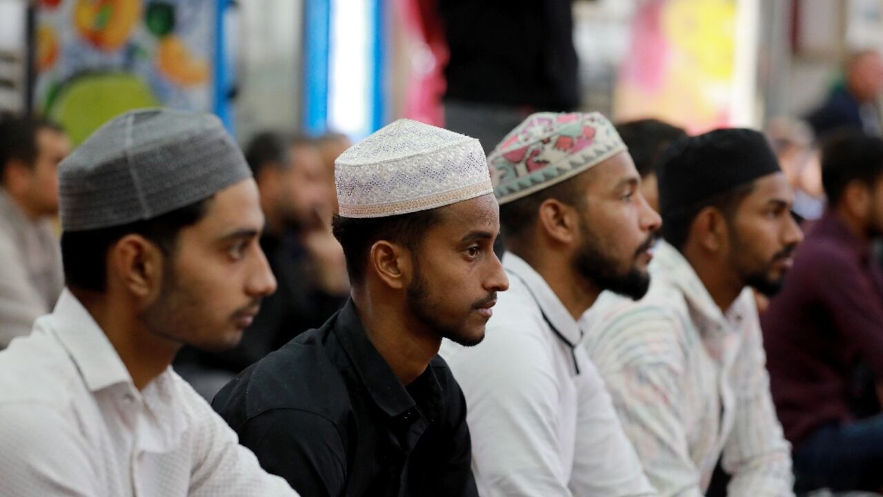 Foreign workers in Iraq attend prayers at Baghdad's Abdul Qader al-Jilani mosque. The country, better
known for its own exodus of refugees, is home to hundreds of thousands.