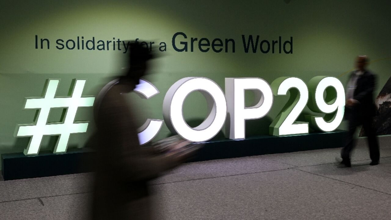 Attendees walk past the COP29 logo during the United Nations climate change talks in Baku, Azerbaijan Attendees walk past the COP29 logo during the United Nations climate change talks in Baku, Azerbaijan