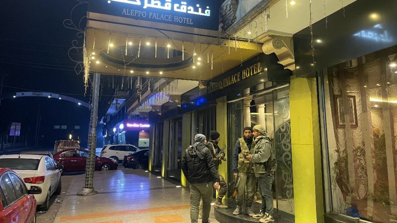 Anti-government fighters gather in front of a hotel in central Aleppo, Syria's second city which a war monitor said jihadist rebels now control most of