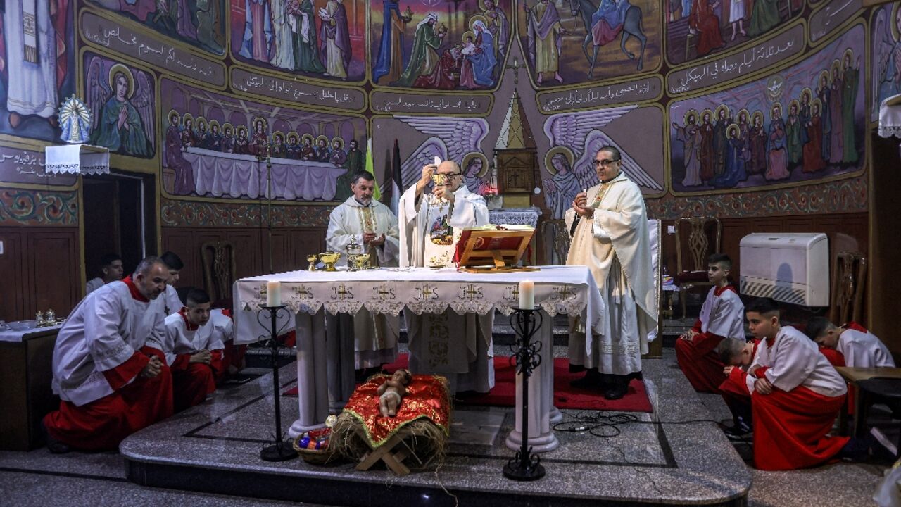 Father Gabriel Romanelli, Parish Priest of the Roman Catholic Church of the Holy Family, during Christmas Eve mass at the church in the Zaytoun neighbourhood of Gaza City