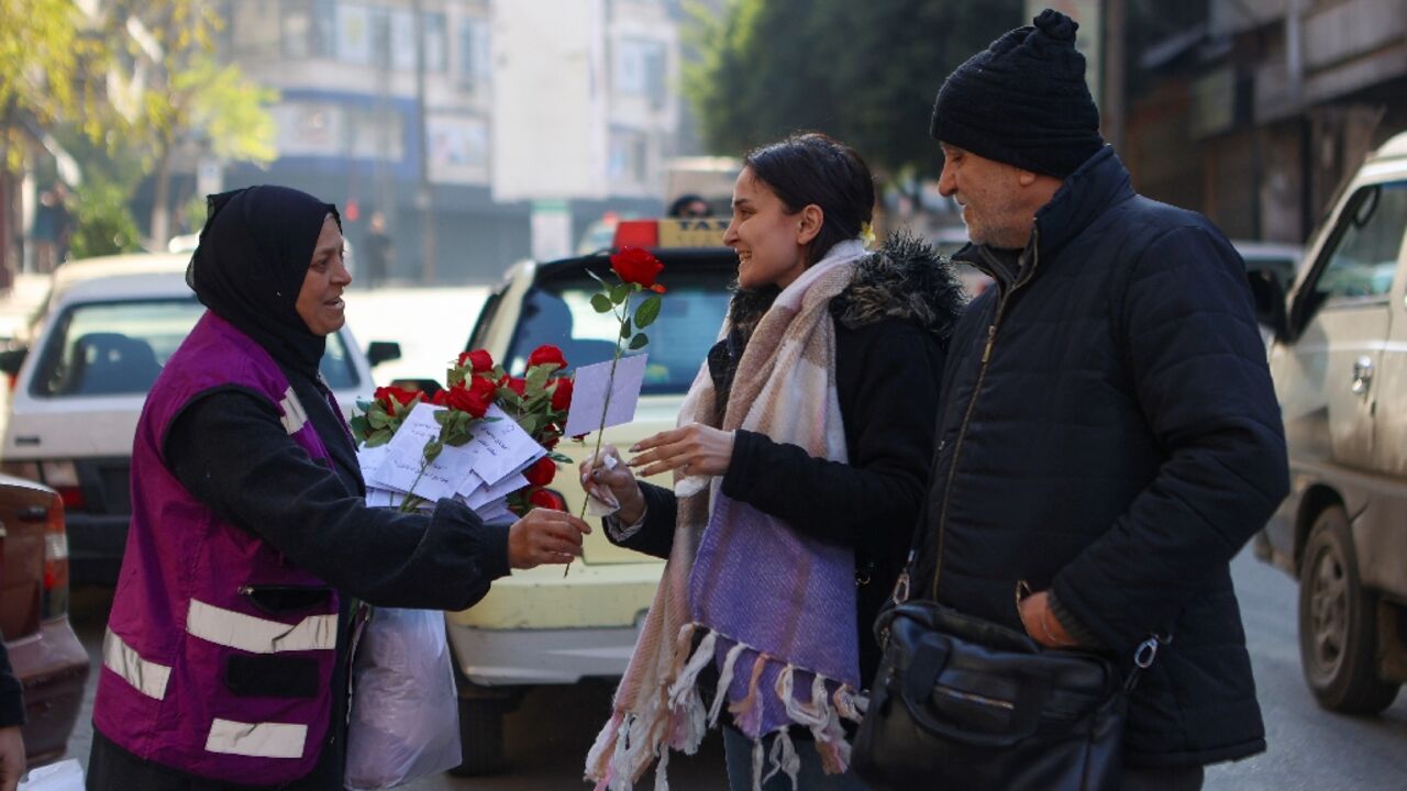 A woman offers a rose to a pedestrian in Aleppo, the first major city taken by rebels on their rapid push that ended with the fall of Bashar al-Assad's government A woman offers a rose to a pedestrian in Aleppo, the first major city taken by rebels on their rapid push that ended with the fall of Bashar al-Assad's government