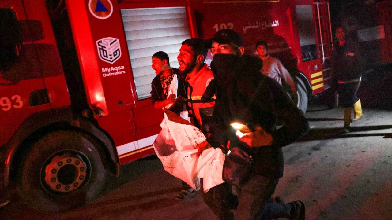 People carry away a victim after an Israeli strike hit a makeshift camp for displaced Palestinians in southern Gaza People carry away a victim after an Israeli strike hit a makeshift camp for displaced Palestinians in southern Gaza