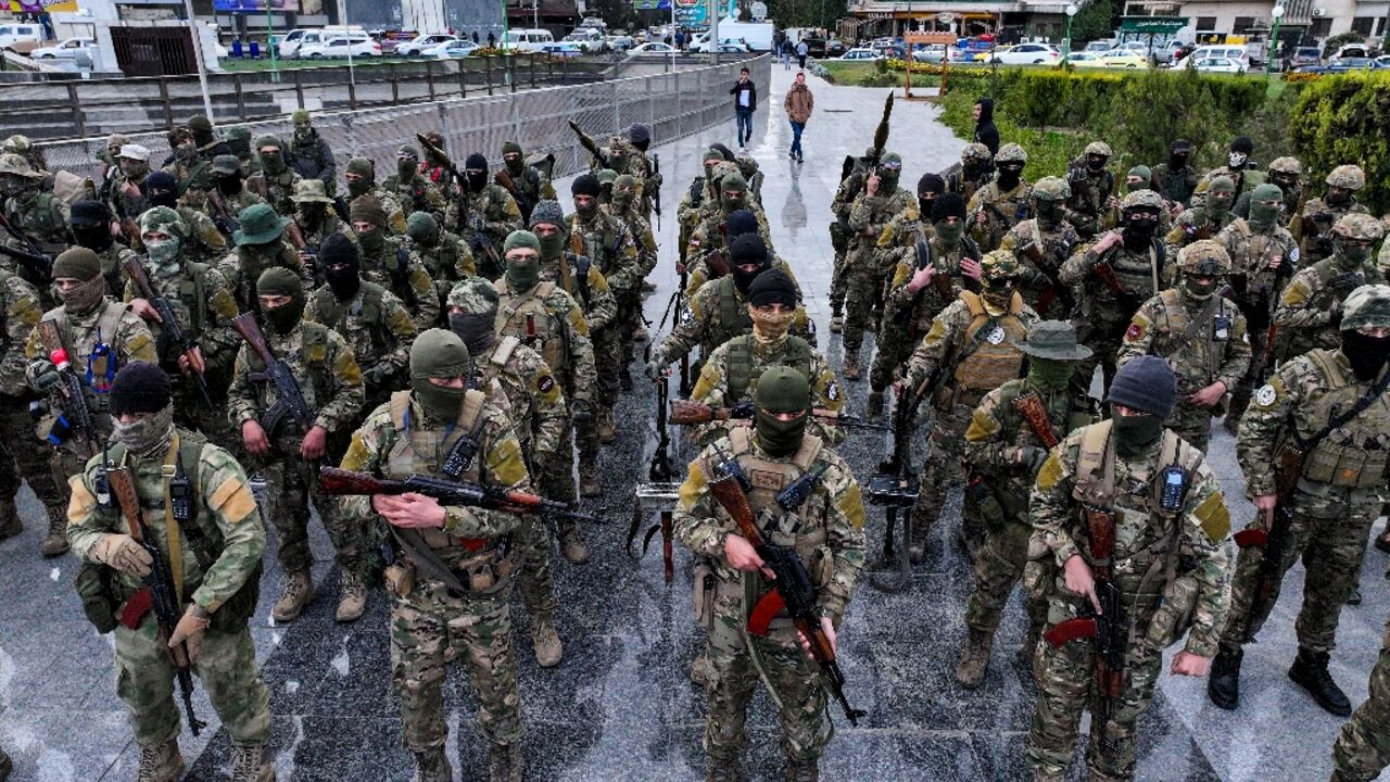 Fighters affiliated with Syria's new administration at a military parade in Damascus