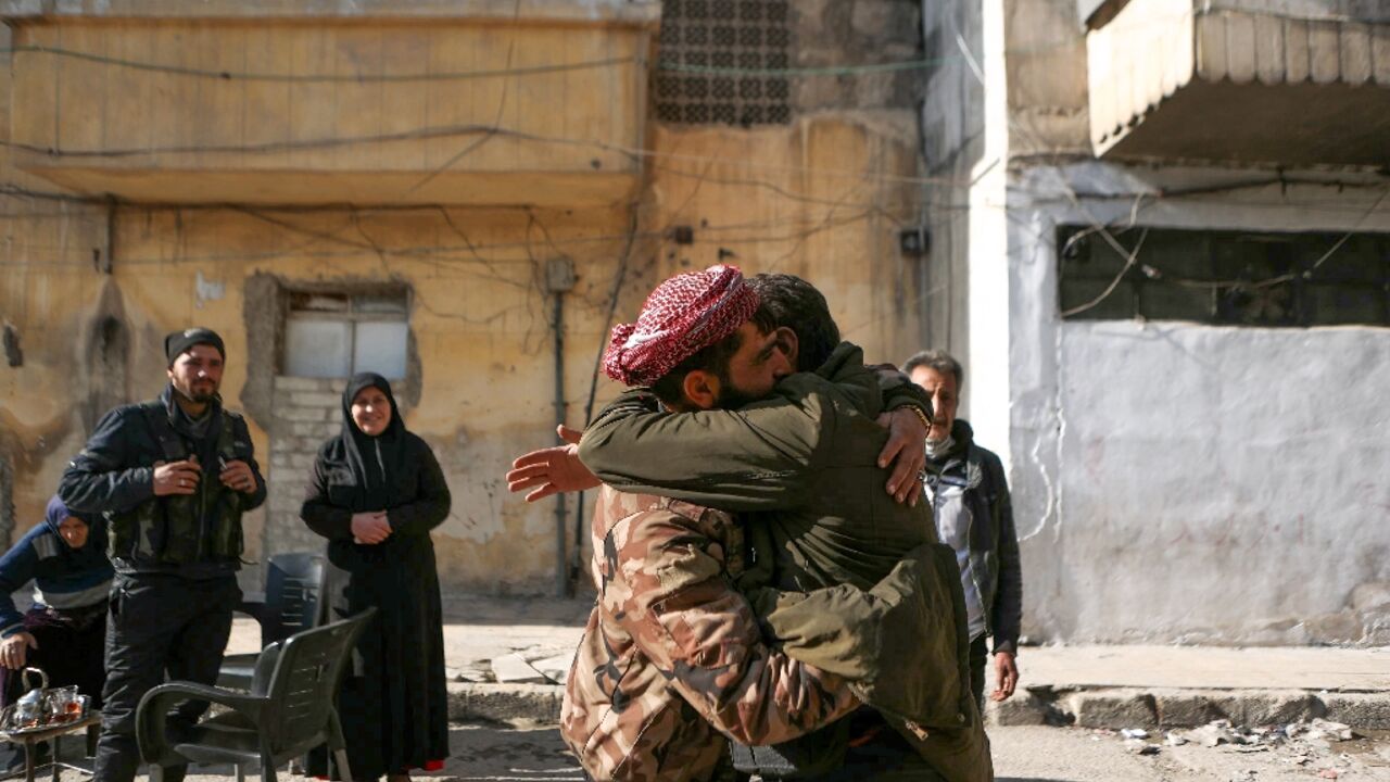 Bahria Bakkur watches on as her son, Mohammed Jomaa, hugs a relative after years of separation