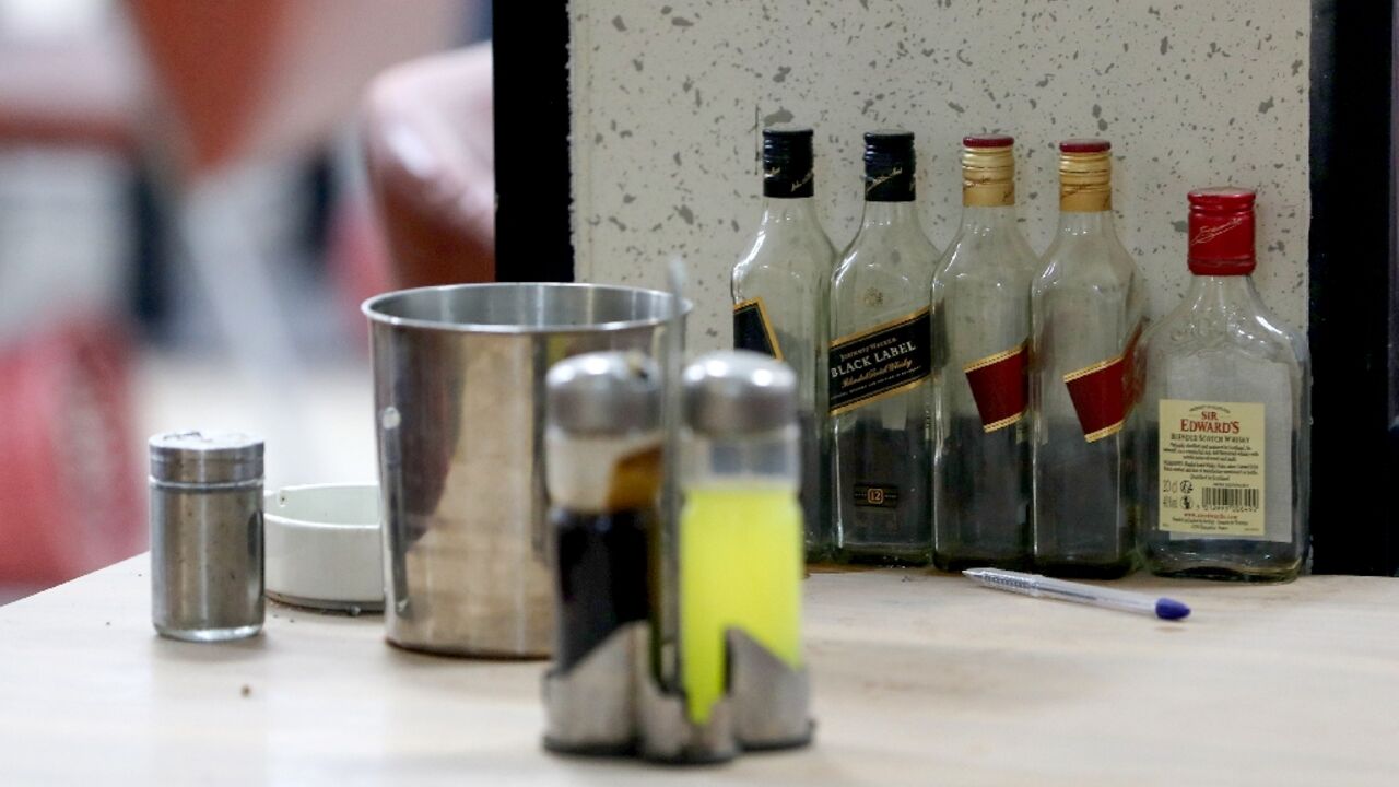 Empty whisky bottles on the bar of a Baghdad club ordered closed by Iraqi security forces 