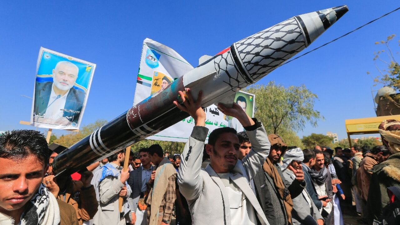 Yemenis carry a mock missile during a rally in solidarity with Palestinians, in the Huthi-controlled capital Sanaa