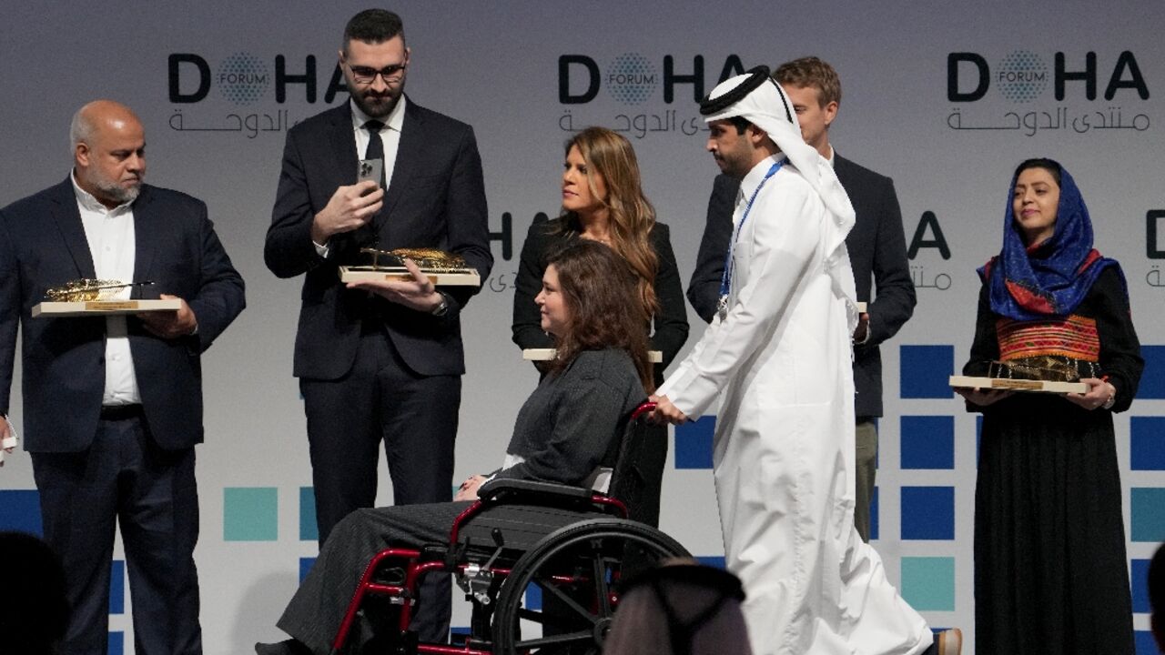 AFP's Christina Assi arriving to receive her award at the Doha Forum in Qatar