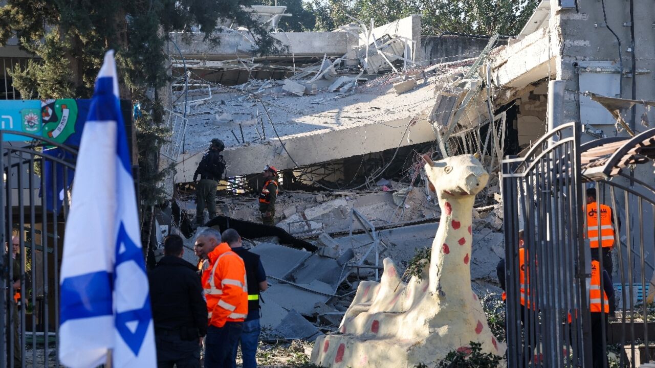 Emergency services personnel inspect the rubble of a destroyed school building in Ramat Gan, near Tel Aviv, after Yemeni rebels fired a missile